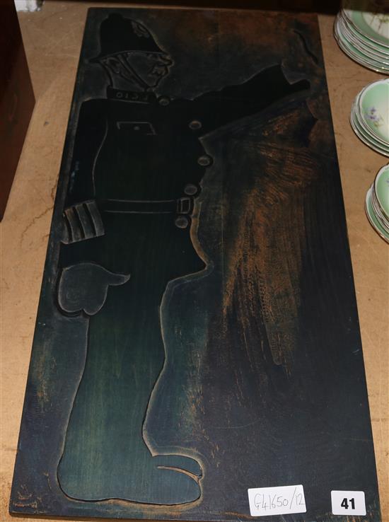 Old carved plate showing a policeman